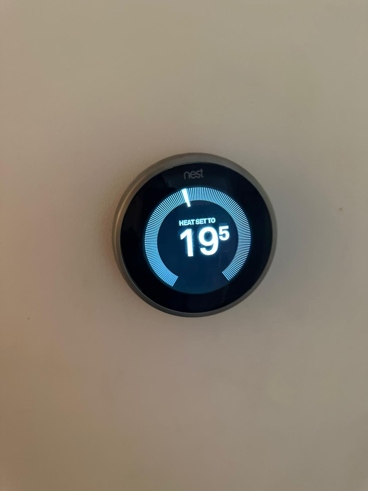 Smart thermostat mounted on a wall
