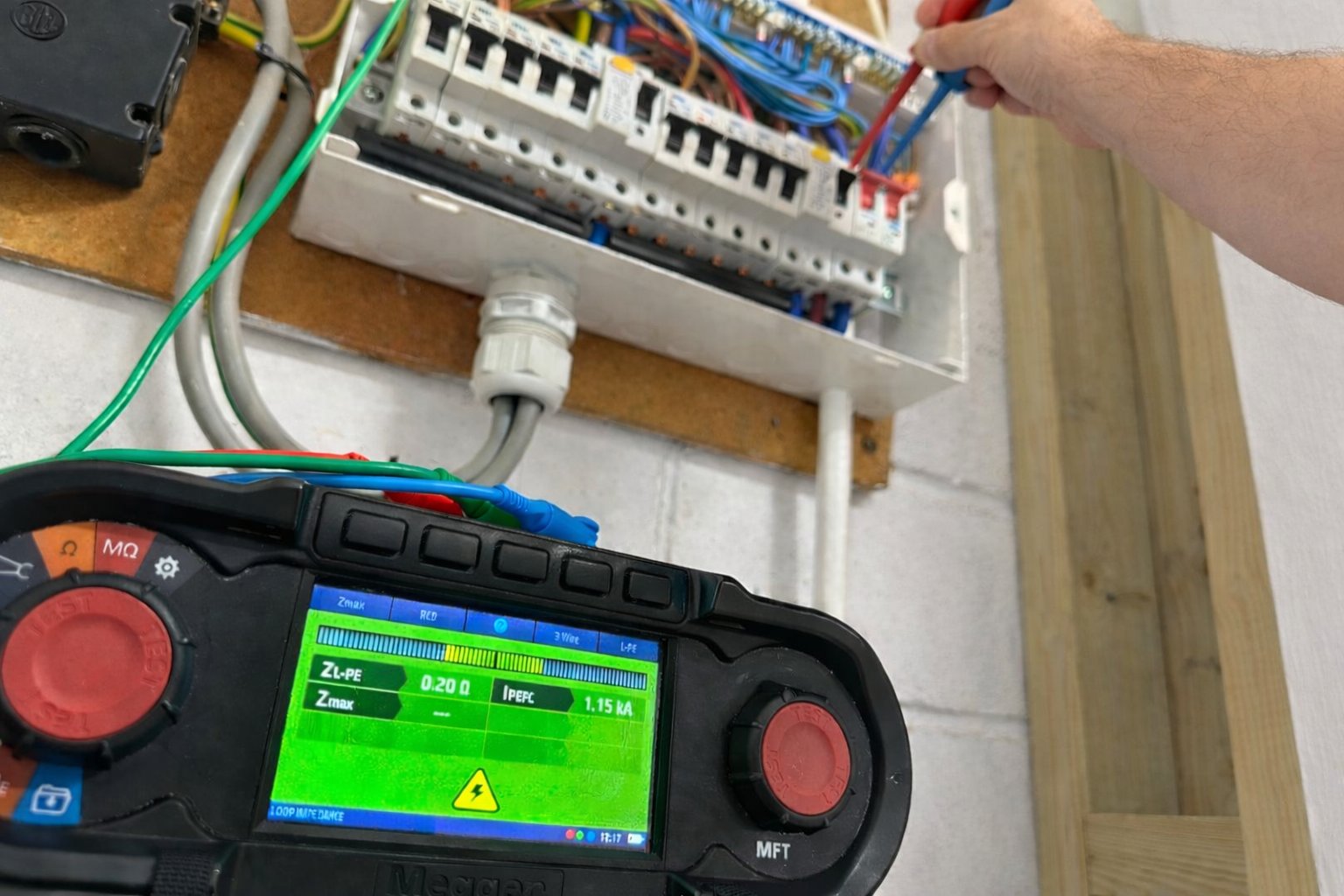 Multifunction tester running a test on a consumer unit