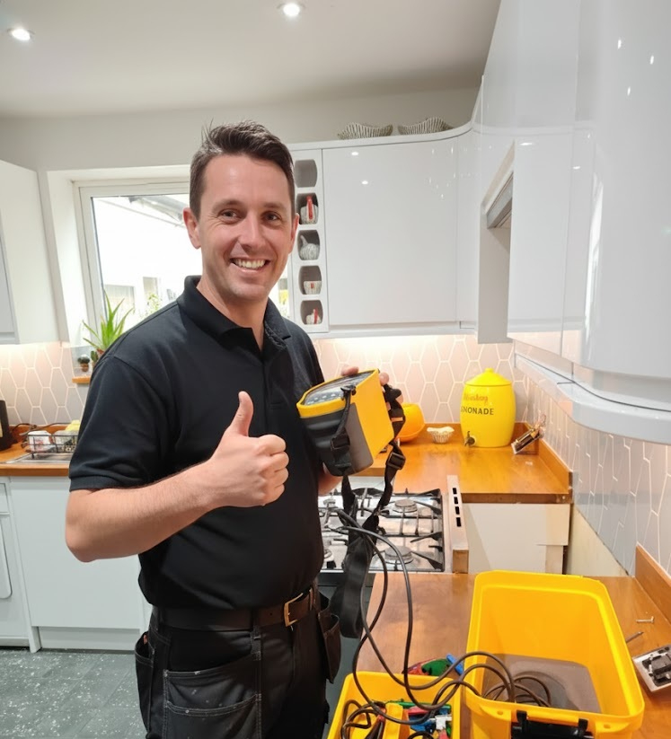 Power Pros electrician holding a test meter